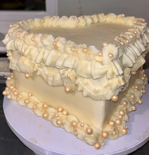 Heart-shaped wedding cake with gold details