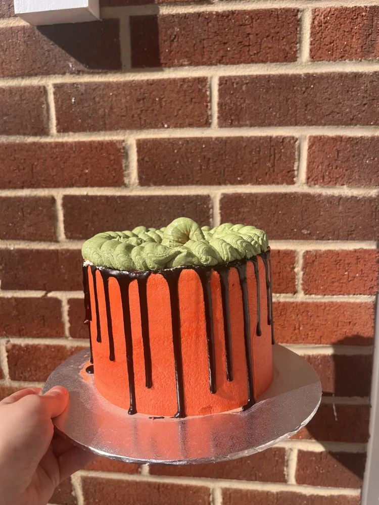 Orange cake with black chocolate drips